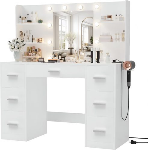 Classic white makeup vanity with Hollywood-style lighted mirror, multiple drawers, and shelves, featuring a 2025 Amazon glam vanity setup with beauty products and a hairdryer.