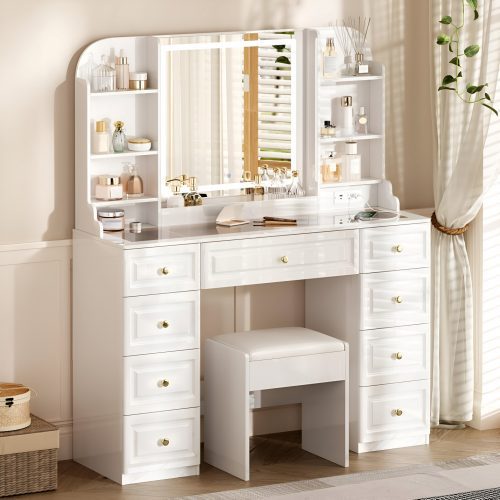 Elegant white makeup vanity with tri-fold LED mirror, multiple drawers, shelves, and cushioned stool, showcasing a 2025 Amazon glam vanity setup with beauty products and decor.