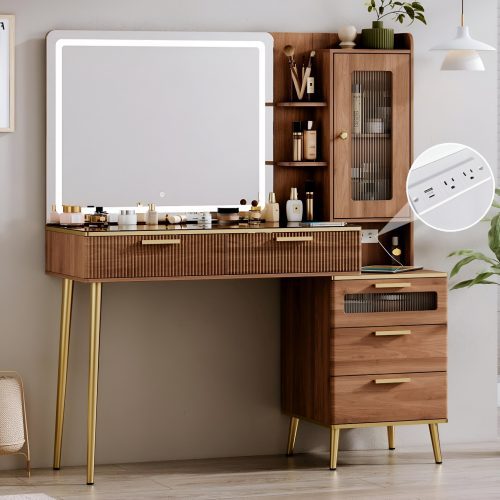 Stylish wooden makeup vanity with gold legs, LED mirror, glass cabinet, and power strip, featuring a 2025 Amazon glam vanity setup with organized beauty products.